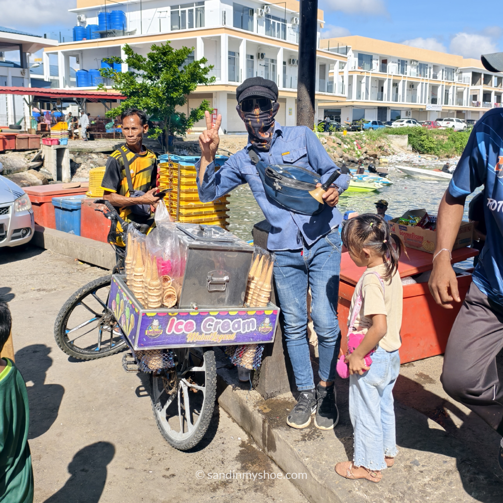Cool looking local ice cream seller in Semporna, posing for a picture on a 1-month Malaysia itinerary
