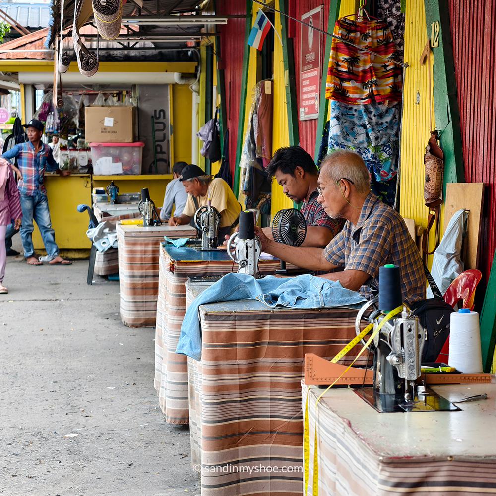 Local tailor repairing clothes at the market in Kota Kinabalu