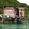 Sea gypsy Malaysia – sea nomad man holding a machete in coastal village