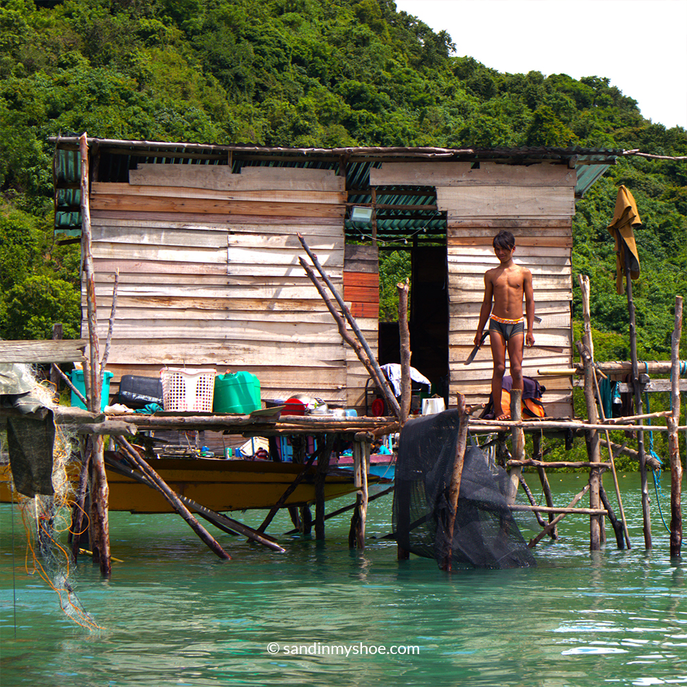 Sea gypsy Malaysia – sea nomad man holding a machete in coastal village