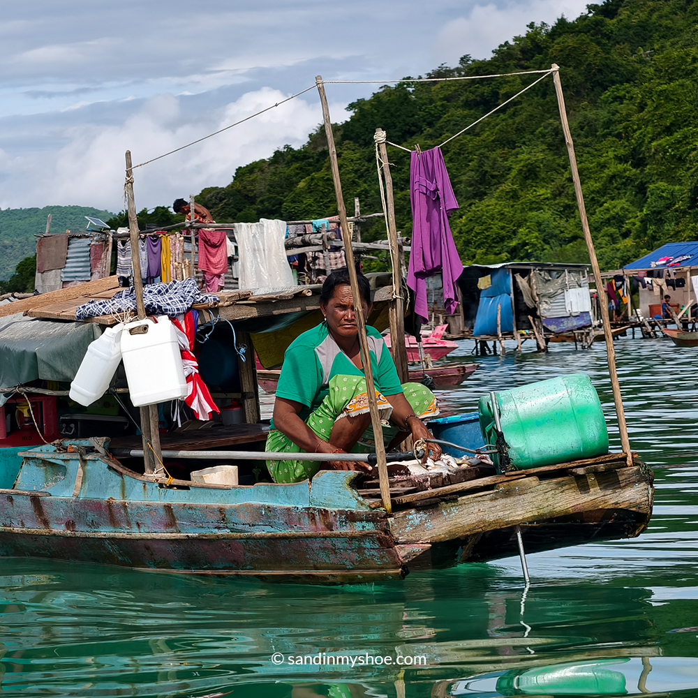 Sea Gypsy Malaysia woman working hard on a floating houseboat