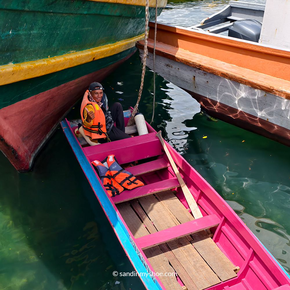 Local Sea Nomad boat captain navigating waters near Semporna, Malaysia