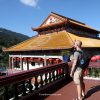 Petteri pondering about his travel budget of Malaysia with a view of Kek Lok Si Temple, a vibrant Buddhist temple complex in Malaysia