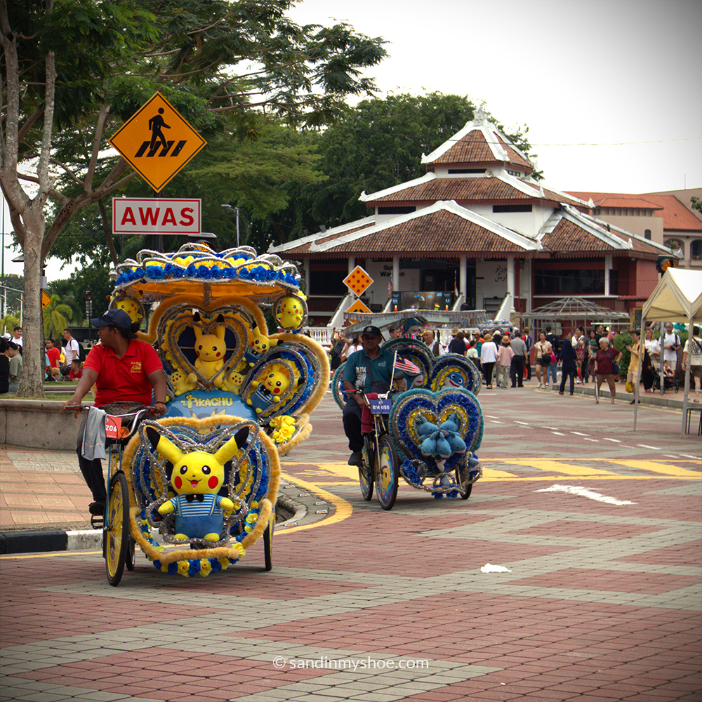 Decorated trishaw in Malacca with Pokémon theme and bright LED lights