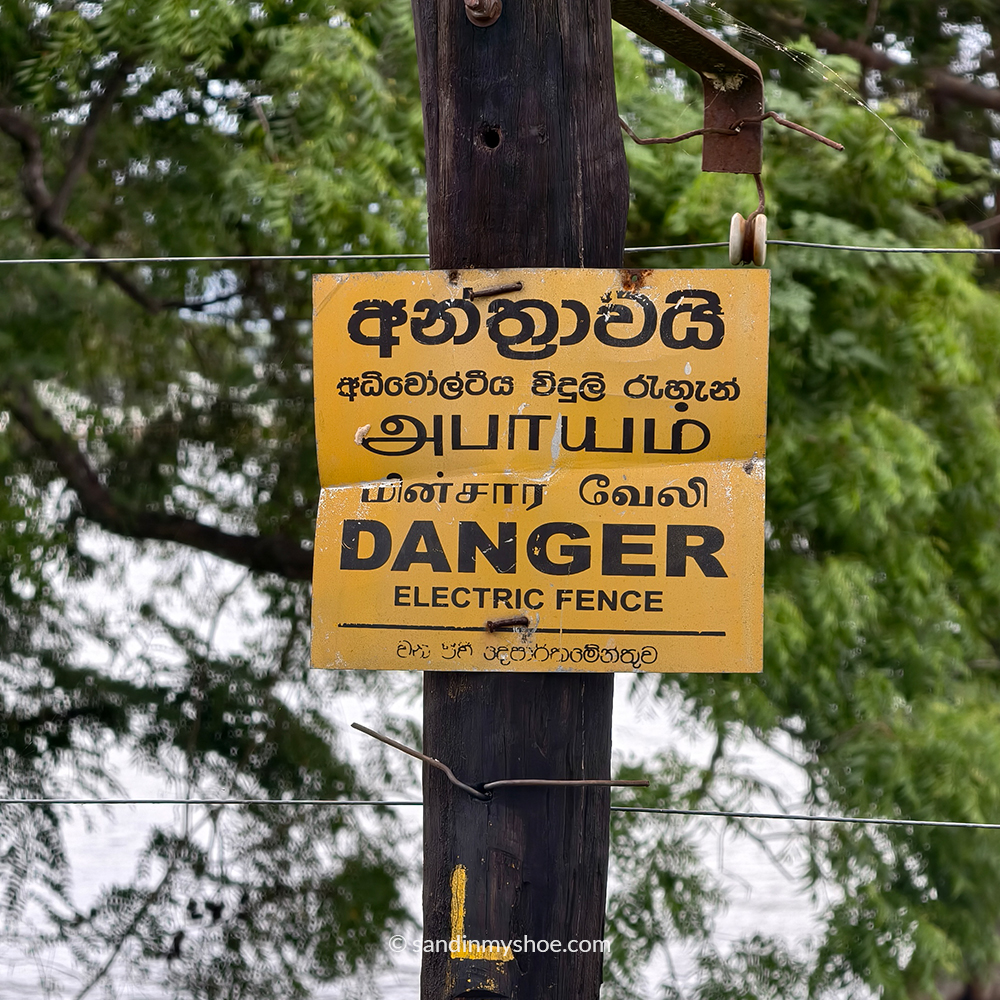 Warning sign for electric fence in a national park in Sri Lanka