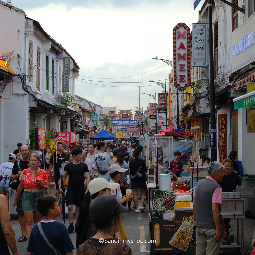 Jonker Street in Malacca bustling with people, shops, and street food stalls