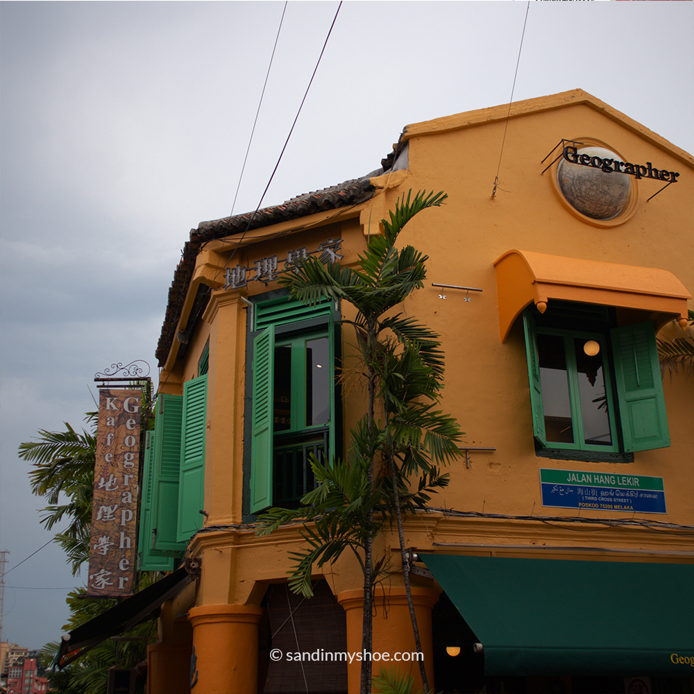 Bright yellow colonial-era building with ornate architectural details in Malacca