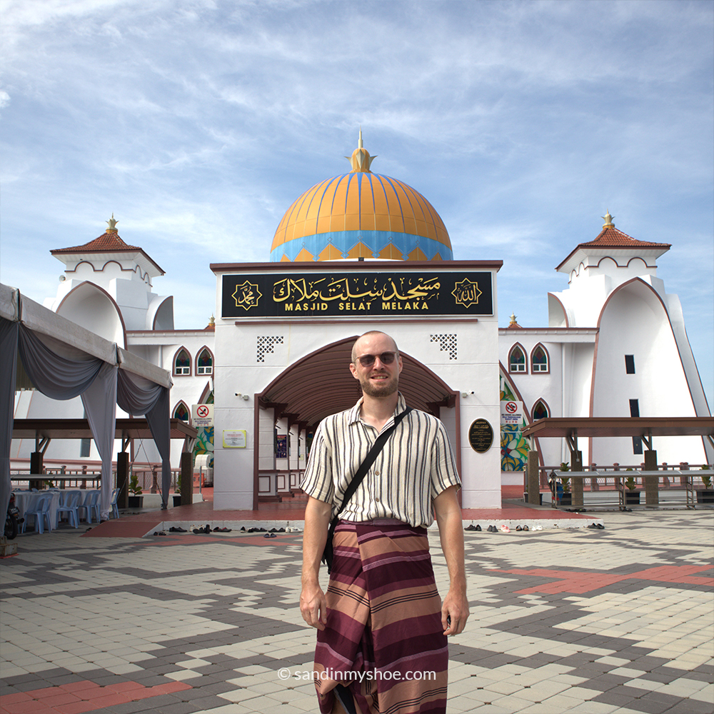 Petteri in front of Masjid Selat, with the mosque appearing to float on the sea