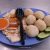 Traditional Malaccan chicken rice balls served with sliced chicken and spicy sauce