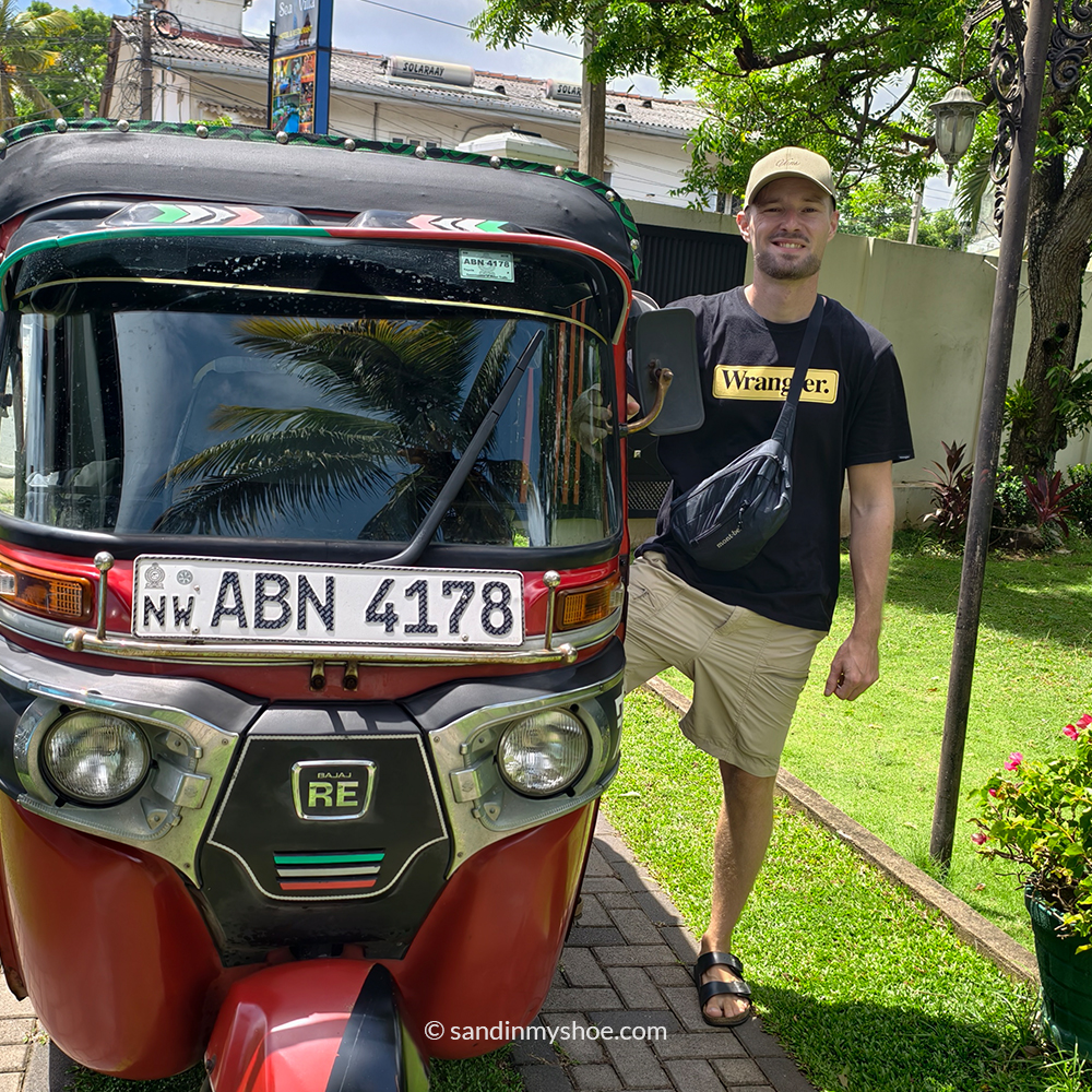 Petteri standing next to his Sri Lanka tuk tuk, preparing for another leg of his tuk tuk itinerary.