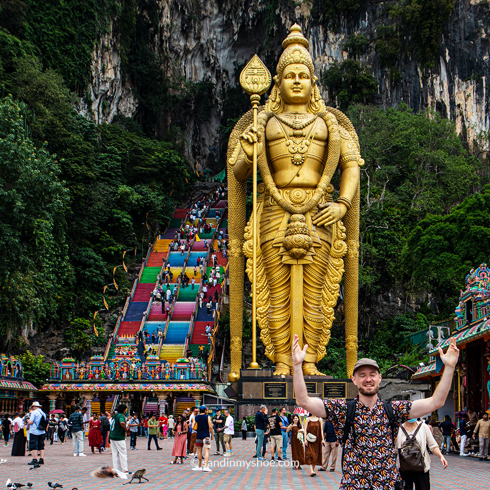 Petteri in front of Batu Caves’ rainbow staircase and towering Lord Murugan statue — a vibrant reason why Kuala Lumpur is worth visiting.