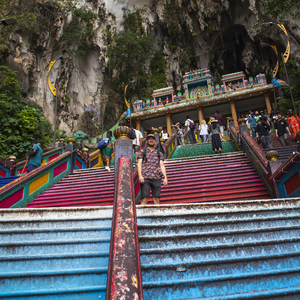 Petteri climbing the rainbow-colored stairs of Batu Caves — a spiritual and visual experience that shows why Kuala Lumpur is worth visiting.