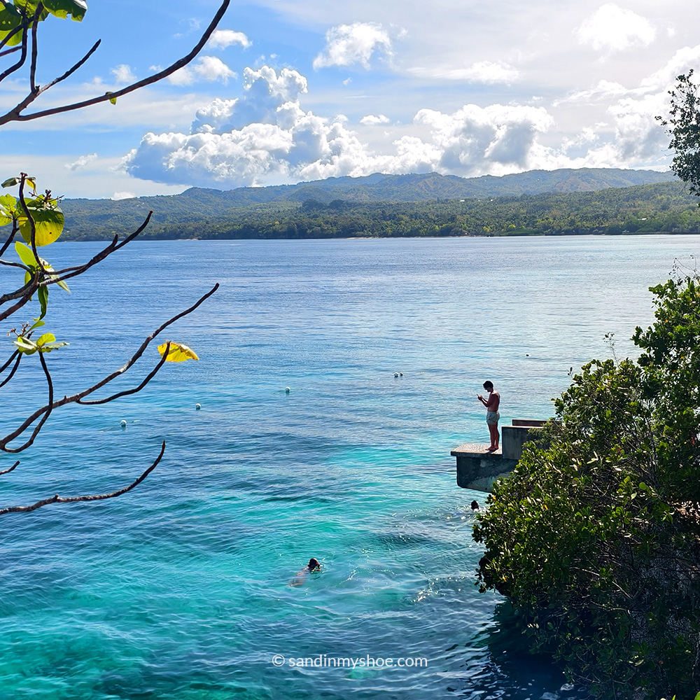 Man getting ready to cliff jump at Salagdoong beach.