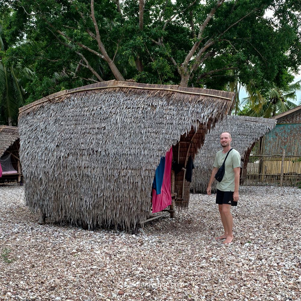 Me standing beside a rustic beach hut used for overnight stays on the Coron–El Nido expedition.