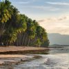 Couple walking on a tropical beach in the Philippines, part of a 2‑week travel itinerary.