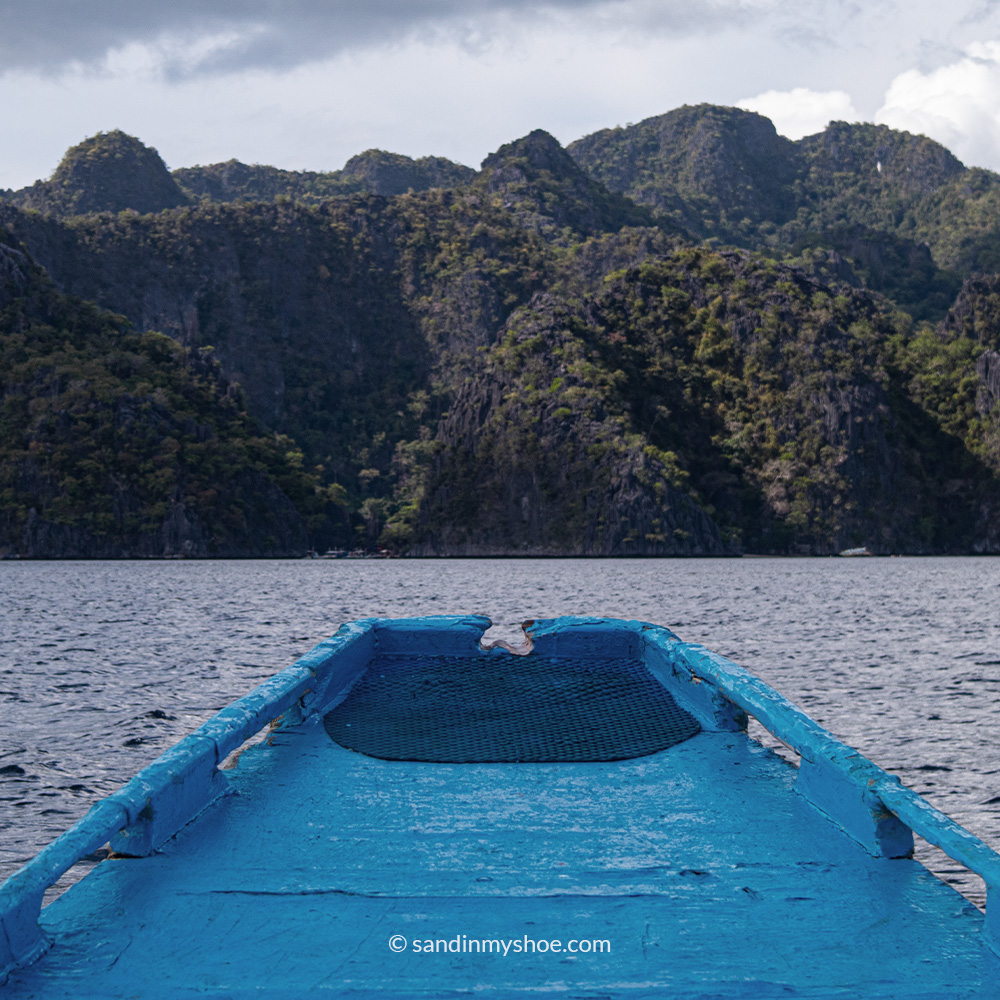 Traditional boat sailing toward Barracuda Lake in Coron, Philippines.
