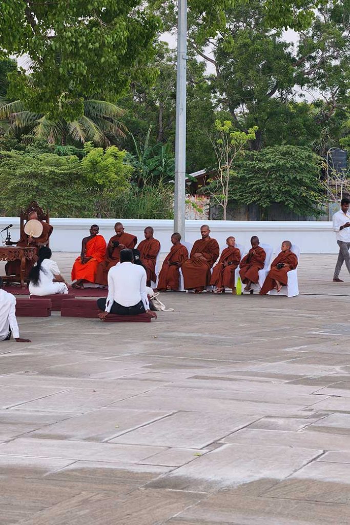 Buddhist monks sitting on chairs