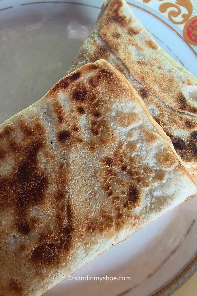 Two delicious chicken rotis on a plate — the best food in Sri Lanka