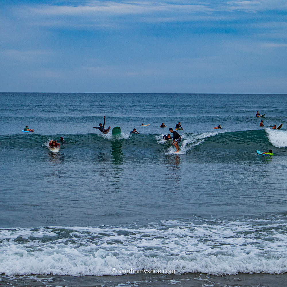 Surfers at Peanut Farm Beach.