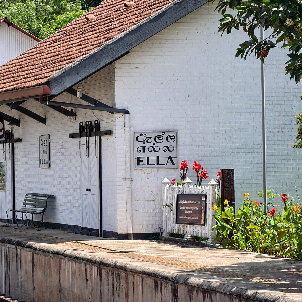 Ella train station sign mounted on the exterior wall of a local house, highlighting the town’s name in Sinhala, Tamil, and English—an iconic sight for travelers exploring things to do in Ella.