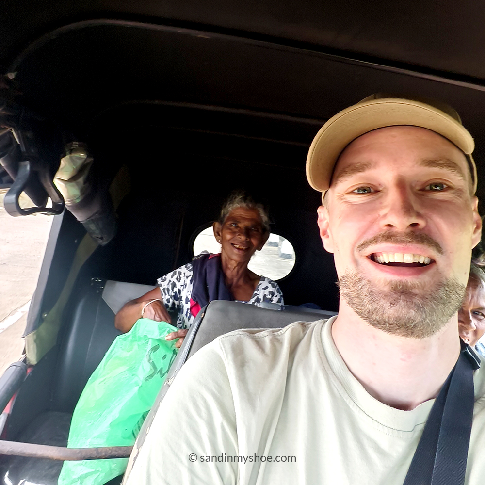 Petteri driving a tuk‑tuk toward Arugam Bay, with strangers he picked up along the way.