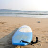 Beach scene in Weligama with a surfboard on the sand during March, showing the warm late‑season conditions travellers consider when asking if March is a good month to visit Sri Lanka.