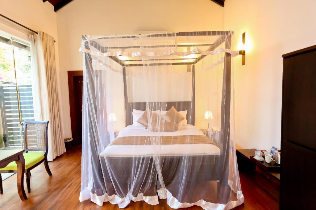 Modern double room at Swanee Grand Hotel in Negombo with clean decor and natural light.