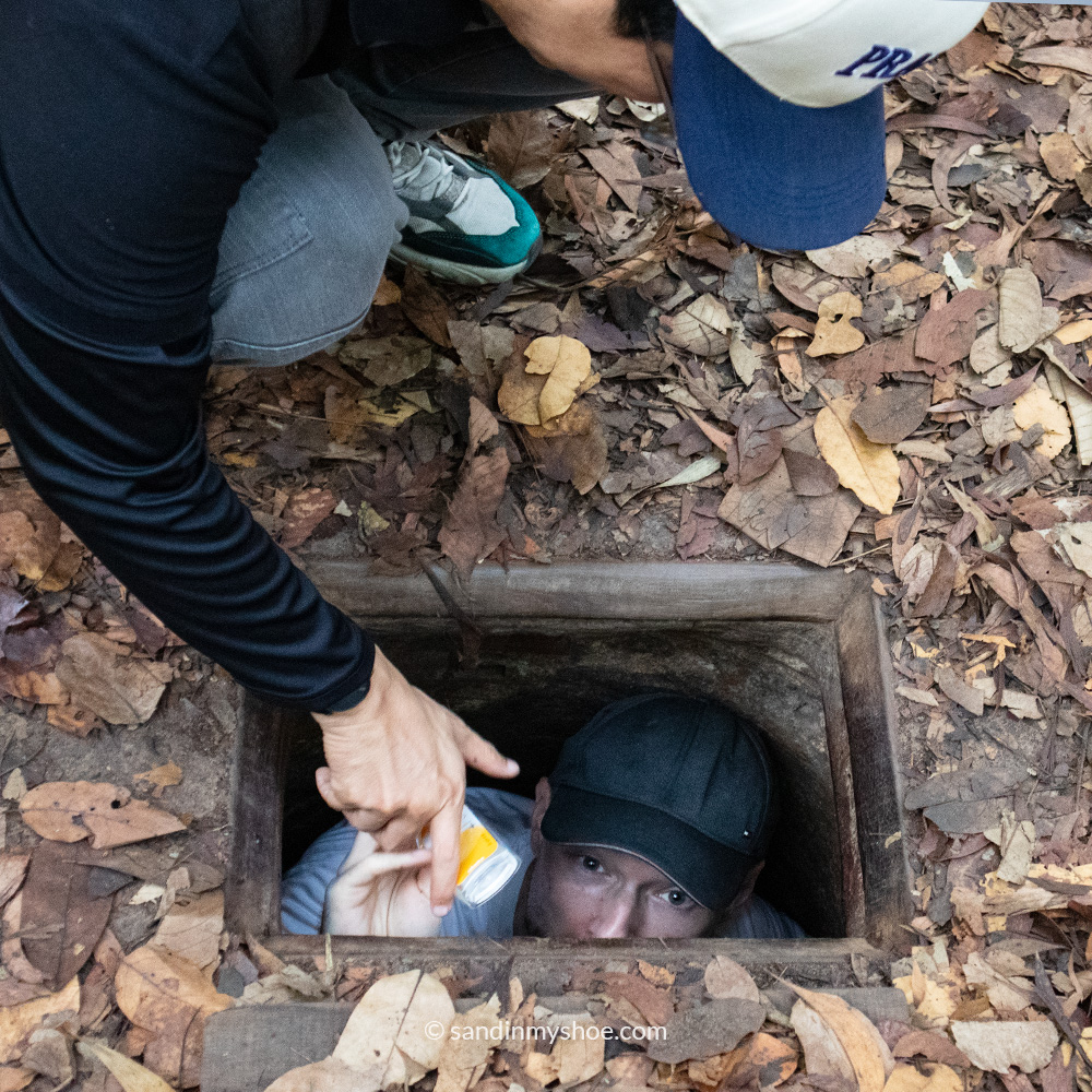 Petteri emerging from an entrance to the Cu Chi Tunnels in Vietnam.