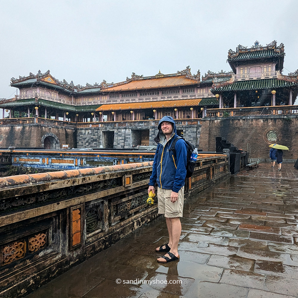 Petteri in front of a Pagoda in Hue during rain