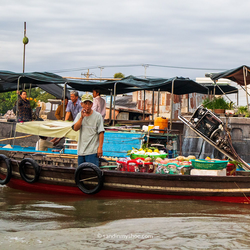 Cai Rang vendor getting a smoke in before announcing his prices to the river