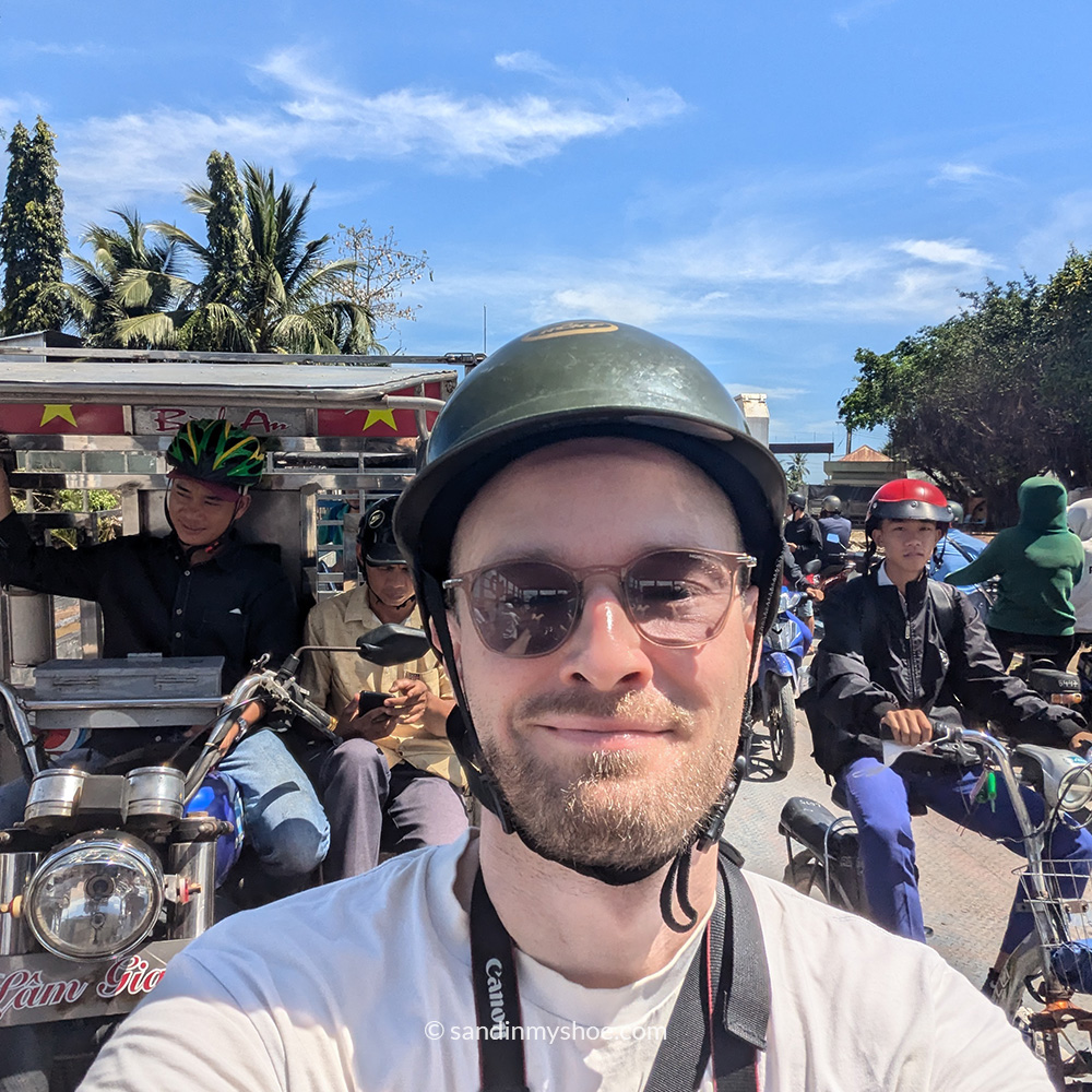 Petteri sitting on a motorbike in the middle of Mekong Delta traffic