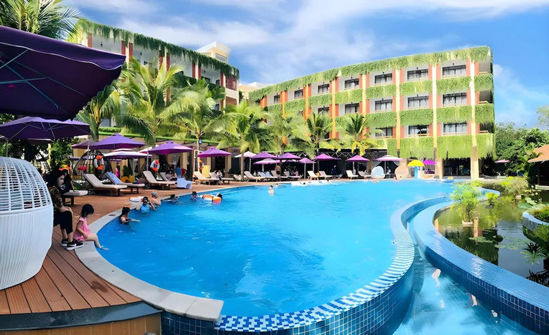 View of Resort Con Khuong showing the pool area, surrounding greenery, and outdoor seating