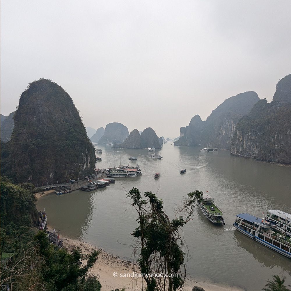 Towering limestone cliffs of Ha Long Bay on a misty day