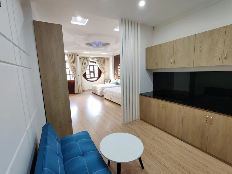 A simple, clean guest room at Winter Spring Homestay in Can Tho, showing the bed, furniture, and basic amenities.