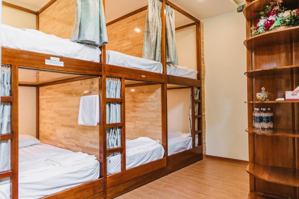 Dormitory room at Chi Homestay with multiple beds in a simple, budget setup.