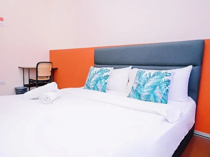 Basic private room at Swing & Pillows with a clean bed and minimal furnishings.