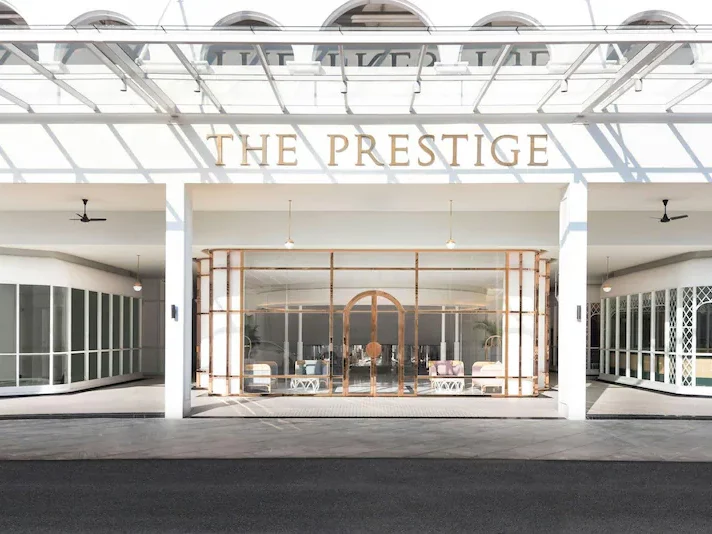 Elegant glass‑atrium lobby of the Prestige Hotel.