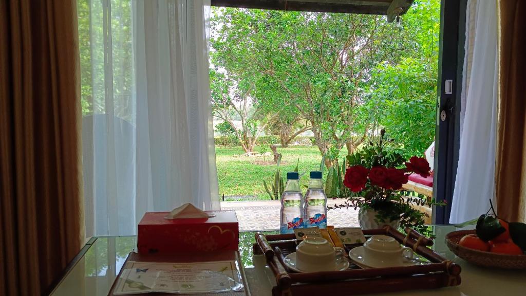 Ground‑level room at Huế Riverside Boutique Resort & Spa with a terrace overlooking the garden.