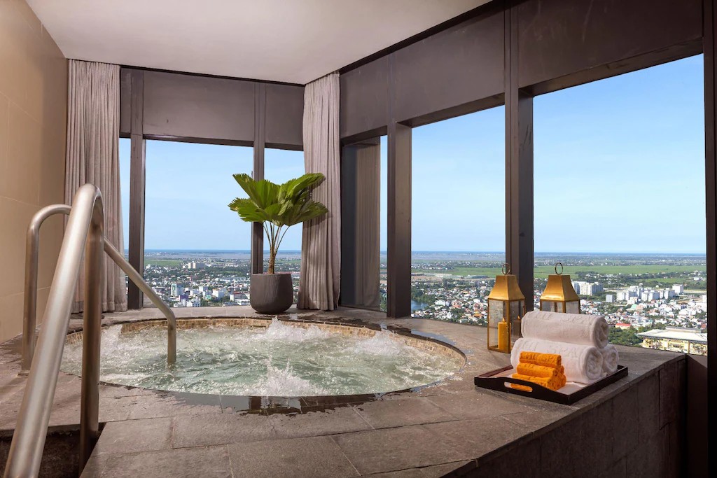 Jacuzzi at Meliá Vinpearl Huế overlooking the city skyline.