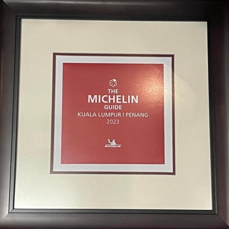 Framed Michelin recognition displayed inside Le Dream Boutique Hotel’s restaurant area.