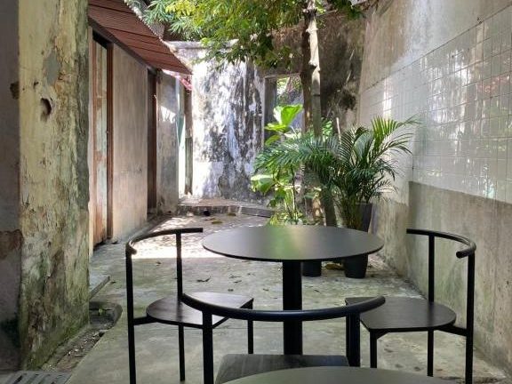 Brutalistic exterior space at The Frame Guesthouse with raw concrete and minimalist design.