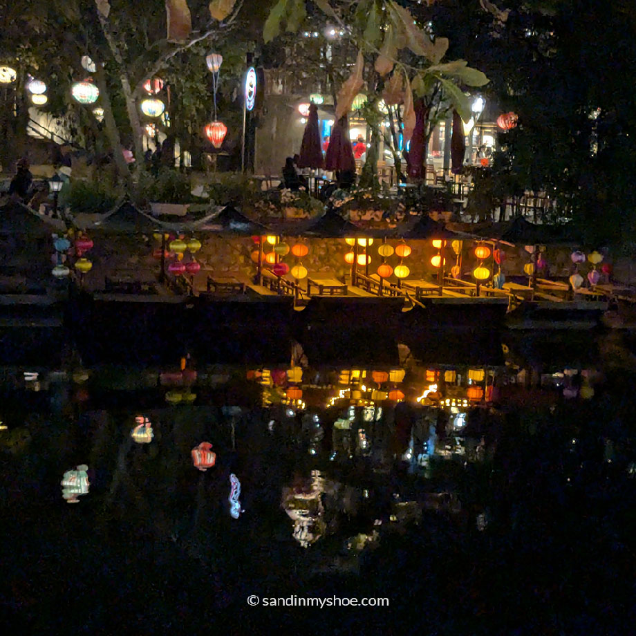 Cozy restaurant at night with lights along the An Cuu River in Hue.