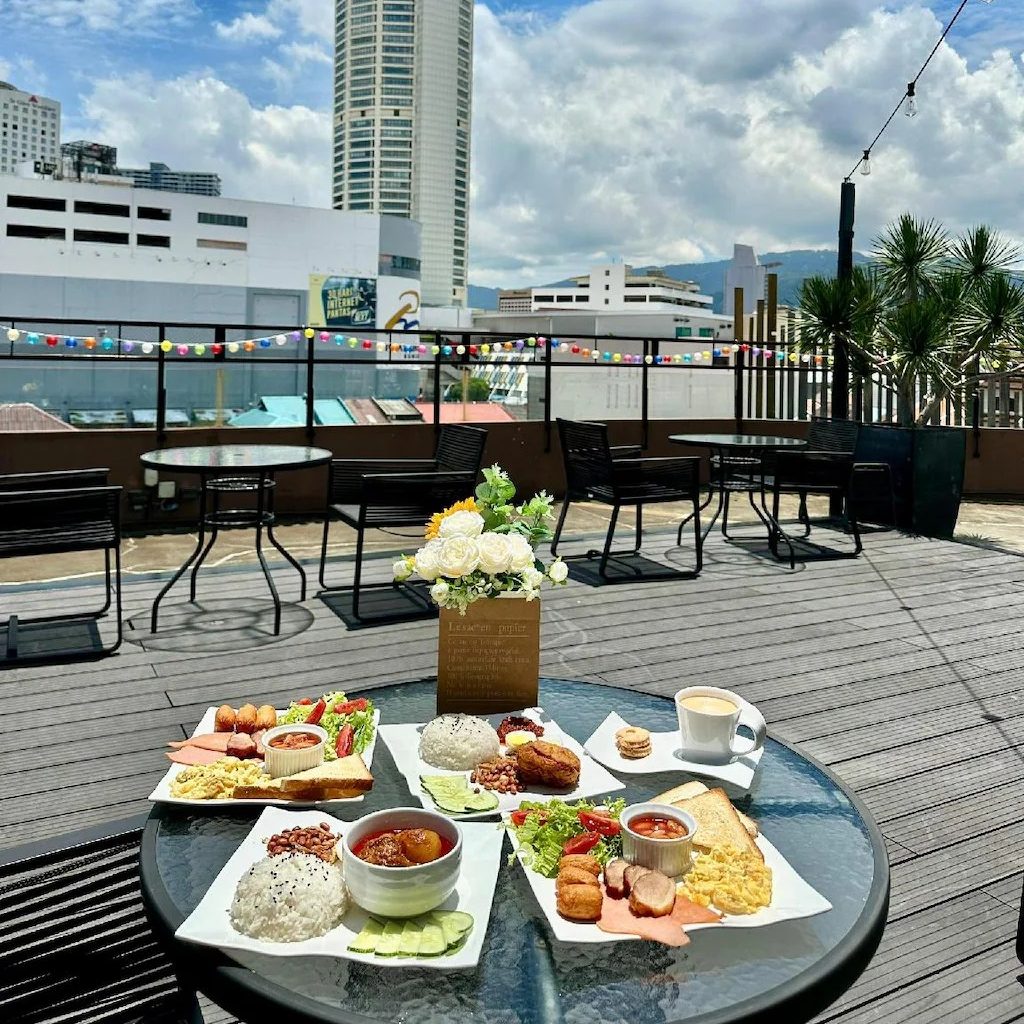 Rooftop dining area at Le Dream Boutique Hotel with tables set for lunch.