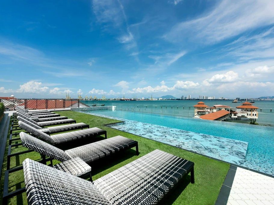 Rooftop pool at The Prestige Hotel Penang with views over the harbor and coastline.
