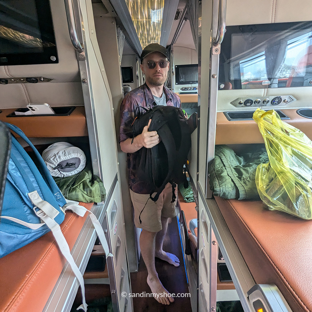 Petteri standing in a narrow corridor of a Vietnamese sleeper bus on the route from Nha Trang to Dalat.