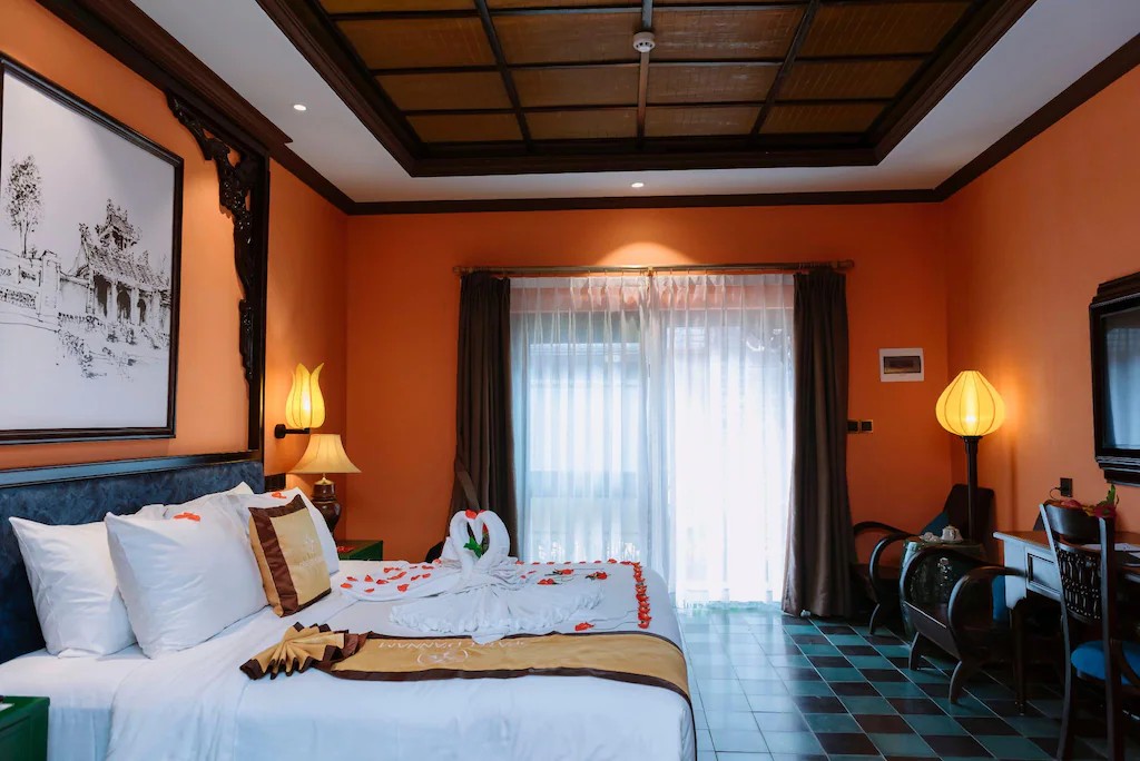 Large double bed at Spatel d'Annam Hotel with modern decor inside the Imperial City.