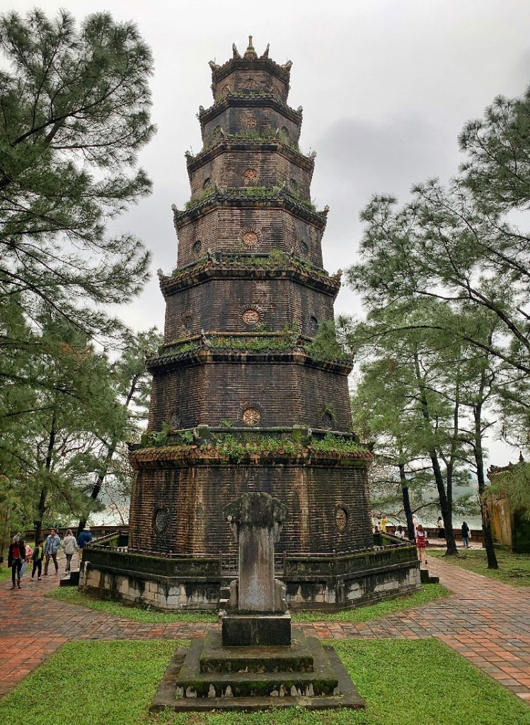 The tall Thien Mu Pagoda in Hue on a cloudy day.