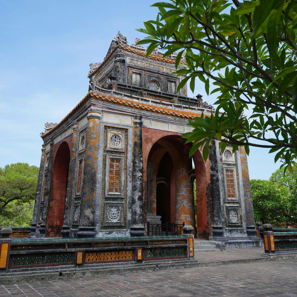 Tự Đức Tomb in Huế with its traditional architecture, stone terraces, and surrounding greenery.