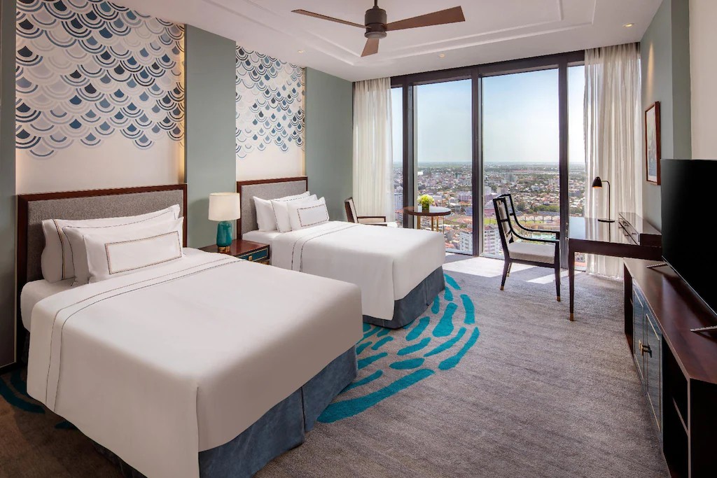 Twin‑bed room at Meliá Vinpearl Huế with city views and modern decor.