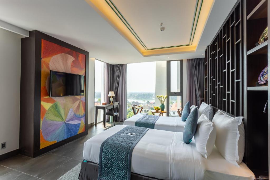 Twin‑bed room at White Lotus Huế Hotel, a 4‑star stay known for great value.